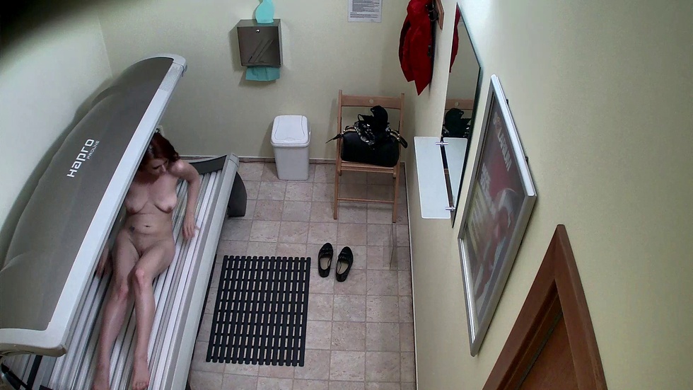 Sexy redhead in solarium