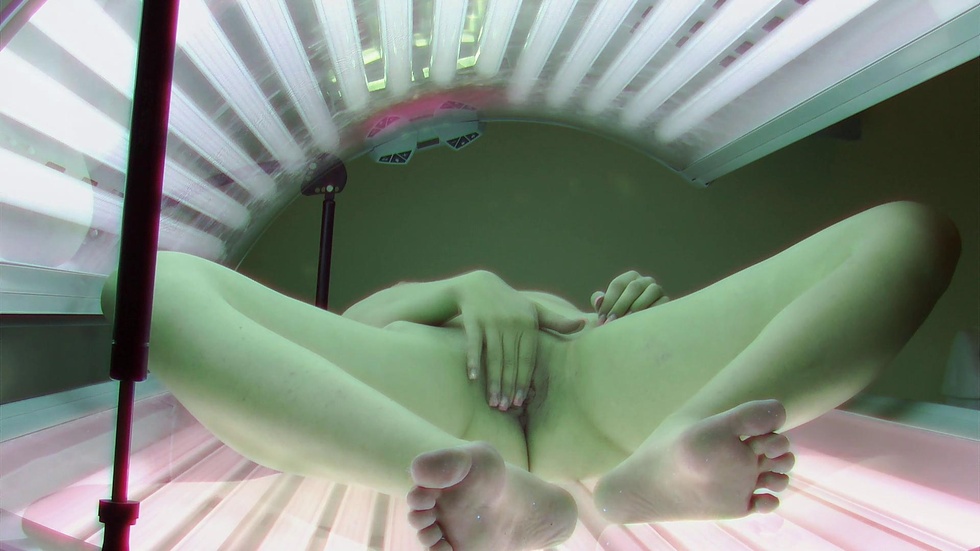 Brunette masturbating in solarium